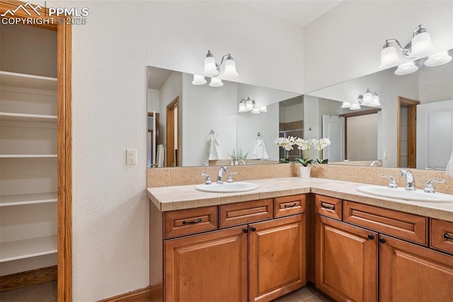 20401 High Pines Dr, Monument, CO 80132 - bathroom featuring double vanity and a textured wall