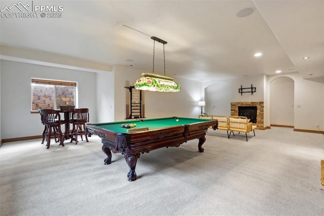 20401 High Pines Dr, Monument, CO 80132 - rec room with light colored carpet, arched walkways, billiards table, a stone fireplace, and recessed lighting