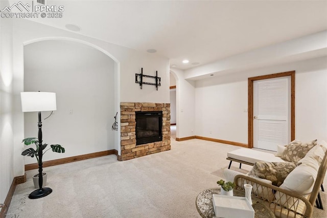 20401 High Pines Dr, Monument, CO 80132 - carpeted living room with arched walkways, a stone fireplace, and recessed lighting