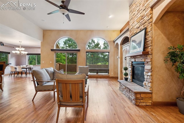 20401 High Pines Dr, Monument, CO 80132 - dining room with a stone fireplace, a chandelier, wood finished floors, and ceiling fan