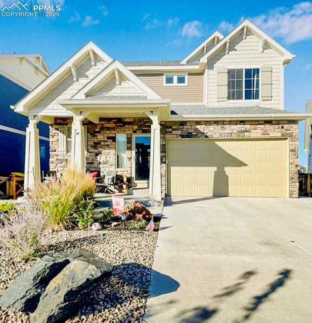 6640 Backcountry Loop, Colorado Springs, CO 80927 - craftsman-style house featuring a garage, driveway, stone siding, and a porch