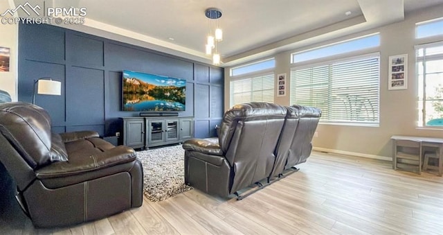 6640 Backcountry Loop, Colorado Springs, CO 80927 - living room with a tray ceiling and light wood-style flooring