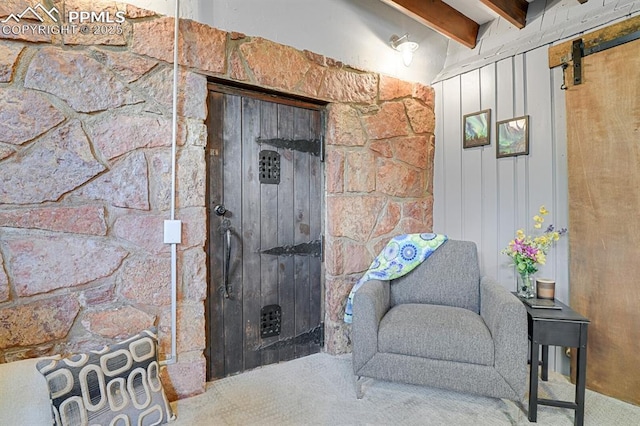 4540 Fountain Ave, Cascade, CO 80809 - sitting room featuring carpet flooring, beam ceiling, and a barn door