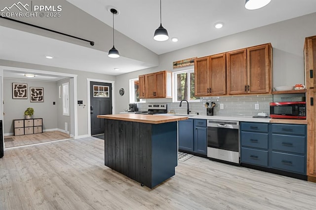4540 Fountain Ave, Cascade, CO 80809 - kitchen with appliances with stainless steel finishes, butcher block counters, backsplash, light wood-style floors, and lofted ceiling