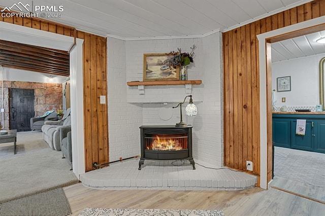 4540 Fountain Ave, Cascade, CO 80809 - detailed view of wood finished floors, wood walls, a wood stove, and crown molding
