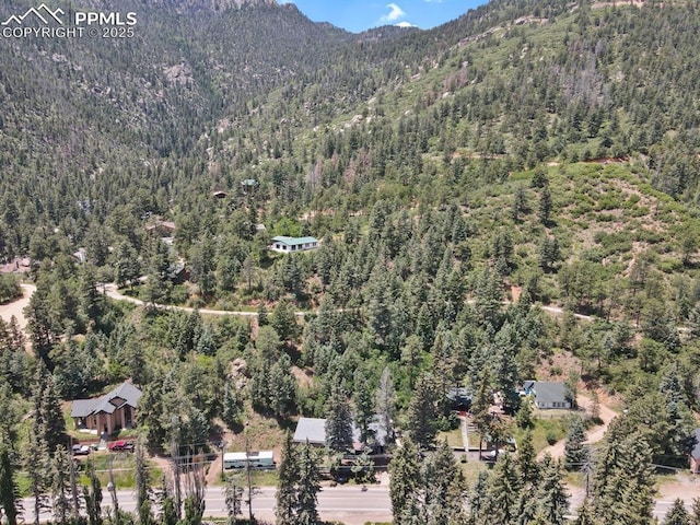 4540 Fountain Ave, Cascade, CO 80809 - aerial view of property and surrounding area featuring a heavily wooded area and a mountain backdrop