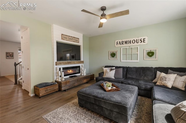 6469 Bodacious Cir, Colorado Springs, CO 80923 - living room with wood finished floors, ceiling fan, and a glass covered fireplace