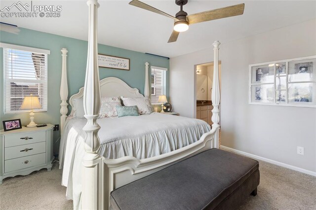 6469 Bodacious Cir, Colorado Springs, CO 80923 - carpeted bedroom with multiple windows, ensuite bathroom, and a ceiling fan