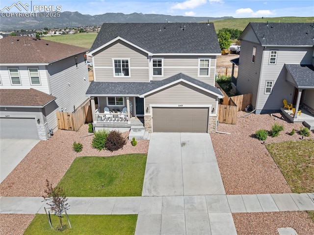 6469 Bodacious Cir, Colorado Springs, CO 80923 - view of front of property featuring covered porch, driveway, a garage, a shingled roof, and a gate