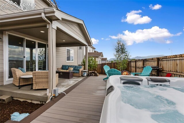 6469 Bodacious Cir, Colorado Springs, CO 80923 - deck with an outdoor living space with a fire pit and a fenced backyard