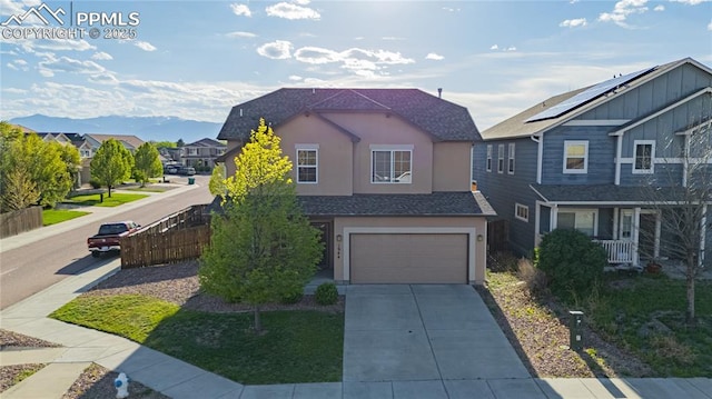 1944 Reed Grass Way, Colorado Springs, CO 80915 - view of front of house with an attached garage, driveway, stucco siding, and a residential view