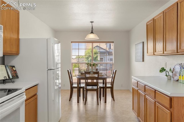 7632 Fiona Ln, Fountain, CO 80817 - kitchen with light countertops, white electric range, pendant lighting, light flooring, and brown cabinetry