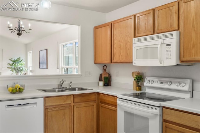 7632 Fiona Ln, Fountain, CO 80817 - kitchen featuring white appliances, light countertops, a chandelier, and decorative light fixtures