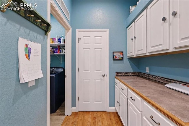 5584 Calamity Jane Ln, Colorado Springs, CO 80923 - laundry area featuring light wood-type flooring and washer / dryer