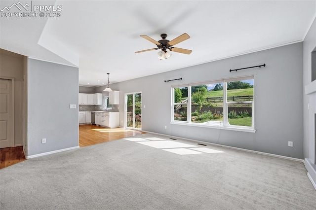 1562 Lookout Springs Dr, Colorado Springs, CO 80921 - unfurnished living room with light colored carpet and a ceiling fan