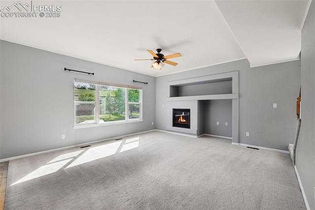 1562 Lookout Springs Dr, Colorado Springs, CO 80921 - unfurnished living room featuring a glass covered fireplace, ceiling fan, and carpet floors