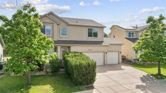 1562 Lookout Springs Dr, Colorado Springs, CO 80921 - traditional-style house featuring driveway, stucco siding, a front yard, and a garage