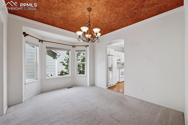 1562 Lookout Springs Dr, Colorado Springs, CO 80921 - unfurnished room featuring light carpet, arched walkways, crown molding, and a chandelier