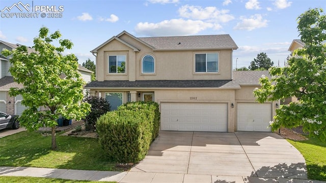 1562 Lookout Springs Dr, Colorado Springs, CO 80921 - traditional-style house with driveway, stucco siding, an attached garage, a front lawn, and roof with shingles