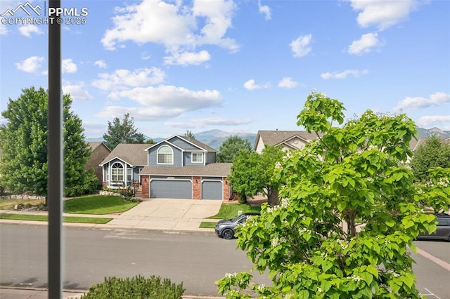 1562 Lookout Springs Dr, Colorado Springs, CO 80921 - view of front of house featuring brick siding, concrete driveway, a garage, and a mountain view