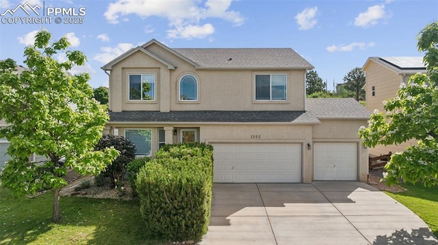 1562 Lookout Springs Dr, Colorado Springs, CO 80921 - traditional-style house with concrete driveway, stucco siding, roof with shingles, and a garage