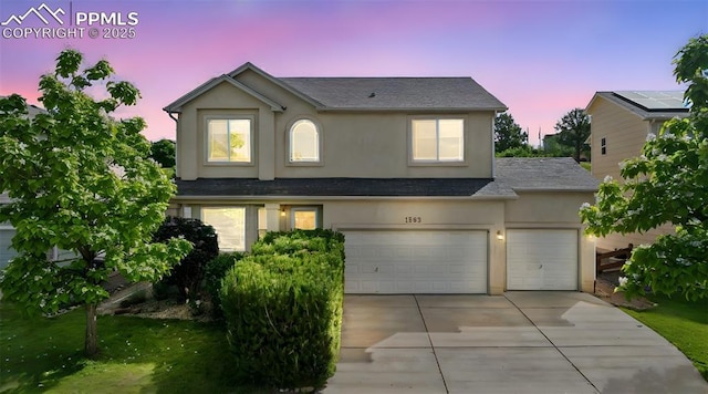 1562 Lookout Springs Dr, Colorado Springs, CO 80921 - view of front of property featuring stucco siding, driveway, a shingled roof, and an attached garage