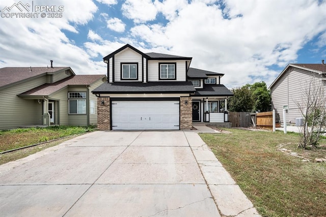 245 Turf Trail Pl, Fountain, CO 80817 - view of front of home with brick siding, driveway, a garage, and roof with shingles