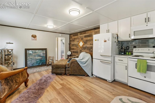 53 Iris Rd, Woodland Park, CO 80863 - kitchen featuring white appliances, open floor plan, white cabinets, light wood-type flooring, and wood walls
