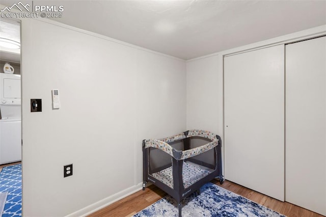 53 Iris Rd, Woodland Park, CO 80863 - bedroom featuring stacked washer / dryer, wood finished floors, and a closet