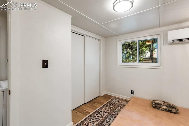 53 Iris Rd, Woodland Park, CO 80863 - unfurnished bedroom featuring an AC wall unit, wood finished floors, and a closet