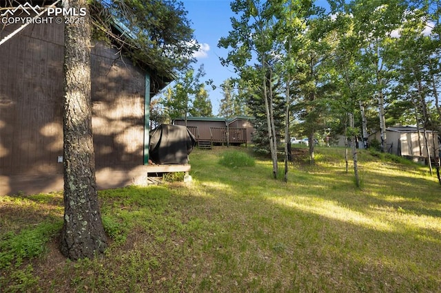 53 Iris Rd, Woodland Park, CO 80863 - view of green lawn featuring a deck