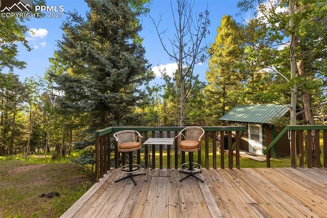 53 Iris Rd, Woodland Park, CO 80863 - wooden terrace with an outdoor structure and view of scattered trees