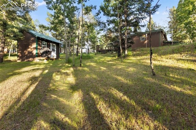53 Iris Rd, Woodland Park, CO 80863 - view of green lawn with a deck and an outdoor structure