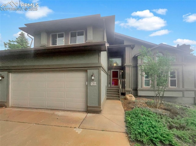 570 Ore Cart Way, Monument, CO 80132 - view of front of house with an attached garage, stucco siding, and concrete driveway