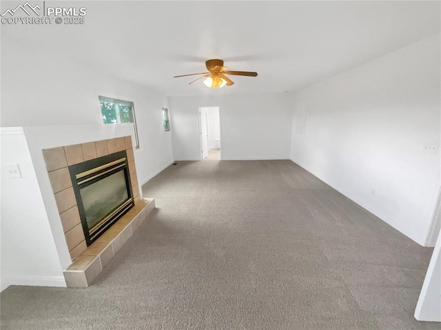 570 Ore Cart Way, Monument, CO 80132 - unfurnished living room with a ceiling fan, light carpet, and a tile fireplace