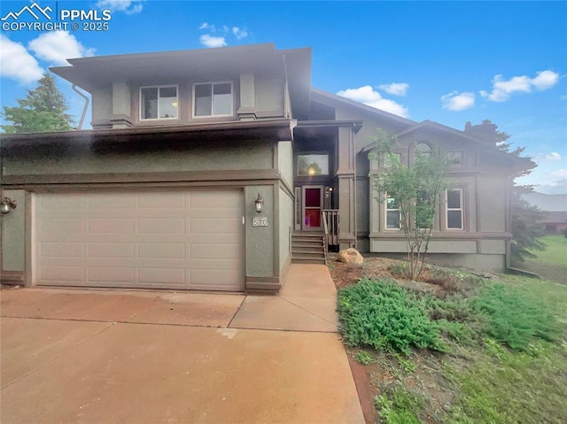 570 Ore Cart Way, Monument, CO 80132 - view of front of home with stucco siding, driveway, and an attached garage