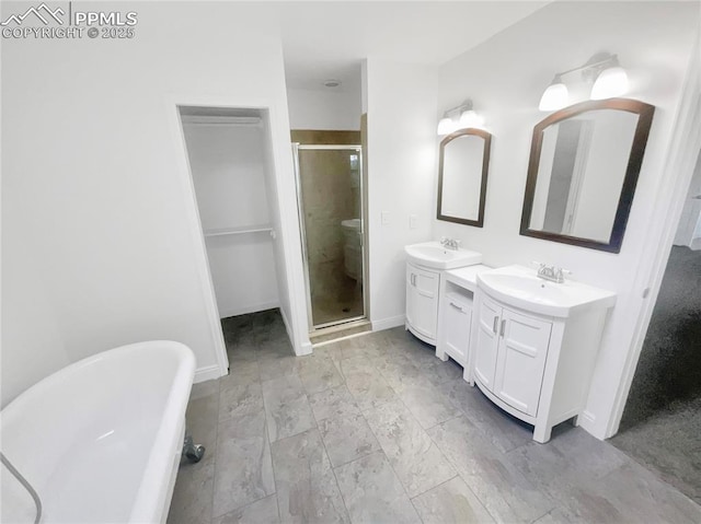 570 Ore Cart Way, Monument, CO 80132 - bathroom with a shower stall, two vanities, and a soaking tub