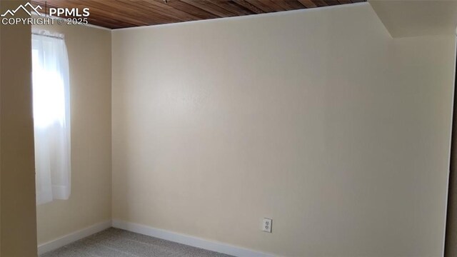 2118 N Chestnut St, Colorado Springs, CO 80907 - carpeted spare room with baseboards and wood ceiling