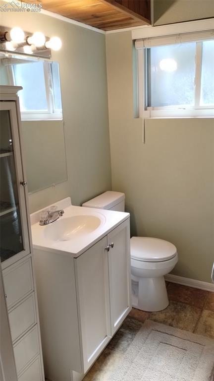 2118 N Chestnut St, Colorado Springs, CO 80907 - half bathroom featuring toilet and vanity