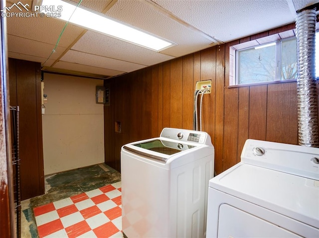 1161 Supple Cir, Pueblo, CO 81006 - washroom featuring independent washer and dryer, wood walls, and tile patterned floors