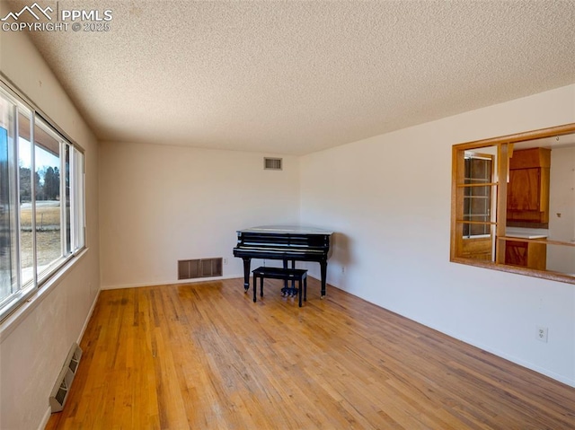 1161 Supple Cir, Pueblo, CO 81006 - sitting room featuring a textured ceiling and hardwood / wood-style flooring