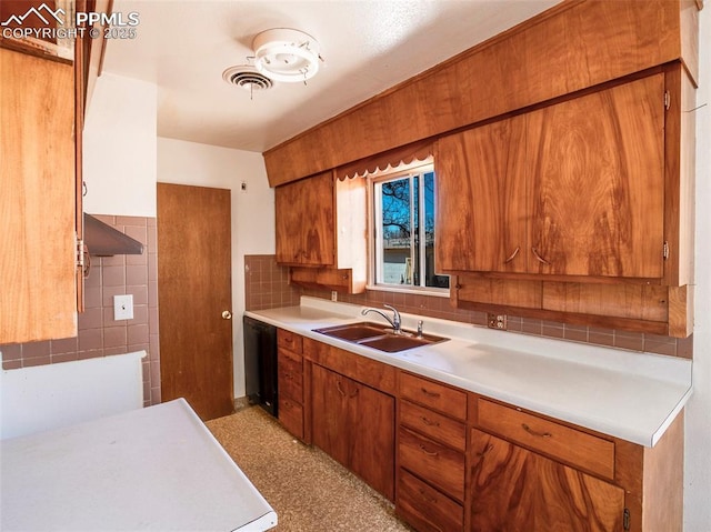 1161 Supple Cir, Pueblo, CO 81006 - kitchen featuring brown cabinets, light countertops, and exhaust hood