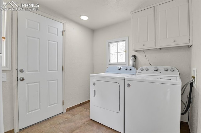 816 Iowa Ave, Colorado Springs, CO 80909 - laundry area with cabinet space, washing machine and clothes dryer, and light tile patterned flooring