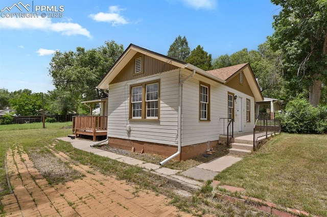 816 Iowa Ave, Colorado Springs, CO 80909 - view of home's exterior featuring a yard and a deck