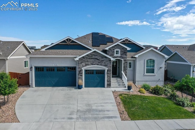 12646 Windingwalk Dr, Peyton, CO 80831 - view of front of property with an attached garage, driveway, roof mounted solar panels, stone siding, and stucco siding