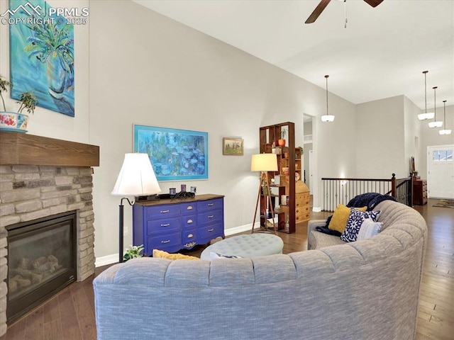 12646 Windingwalk Dr, Peyton, CO 80831 - living room with a ceiling fan, high vaulted ceiling, dark wood finished floors, and a fireplace