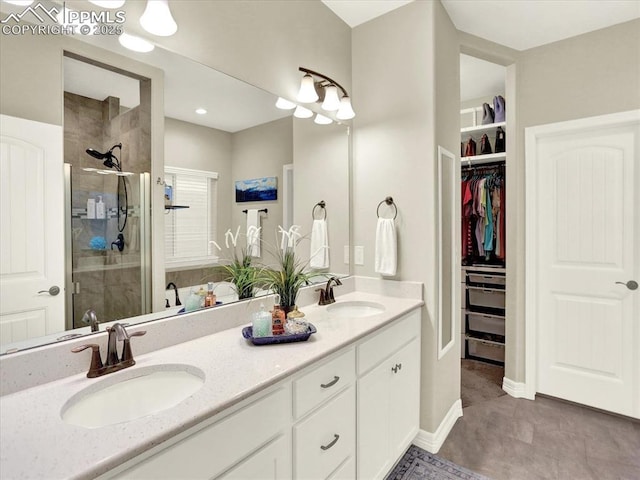 12646 Windingwalk Dr, Peyton, CO 80831 - full bathroom with tiled shower, double vanity, and a walk in closet