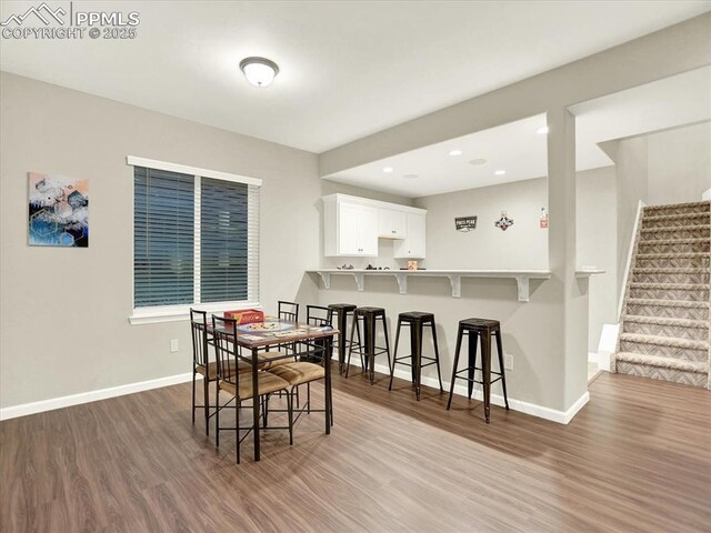 12646 Windingwalk Dr, Peyton, CO 80831 - dining area featuring wood finished floors, stairs, and recessed lighting