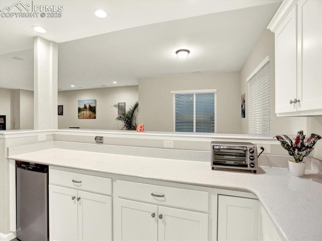 12646 Windingwalk Dr, Peyton, CO 80831 - kitchen with white cabinets, light countertops, a peninsula, and recessed lighting