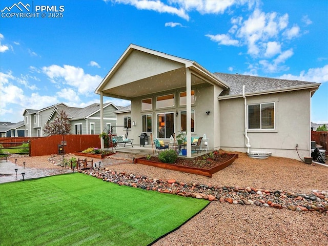 12646 Windingwalk Dr, Peyton, CO 80831 - rear view of property with a patio, stucco siding, and roof with shingles